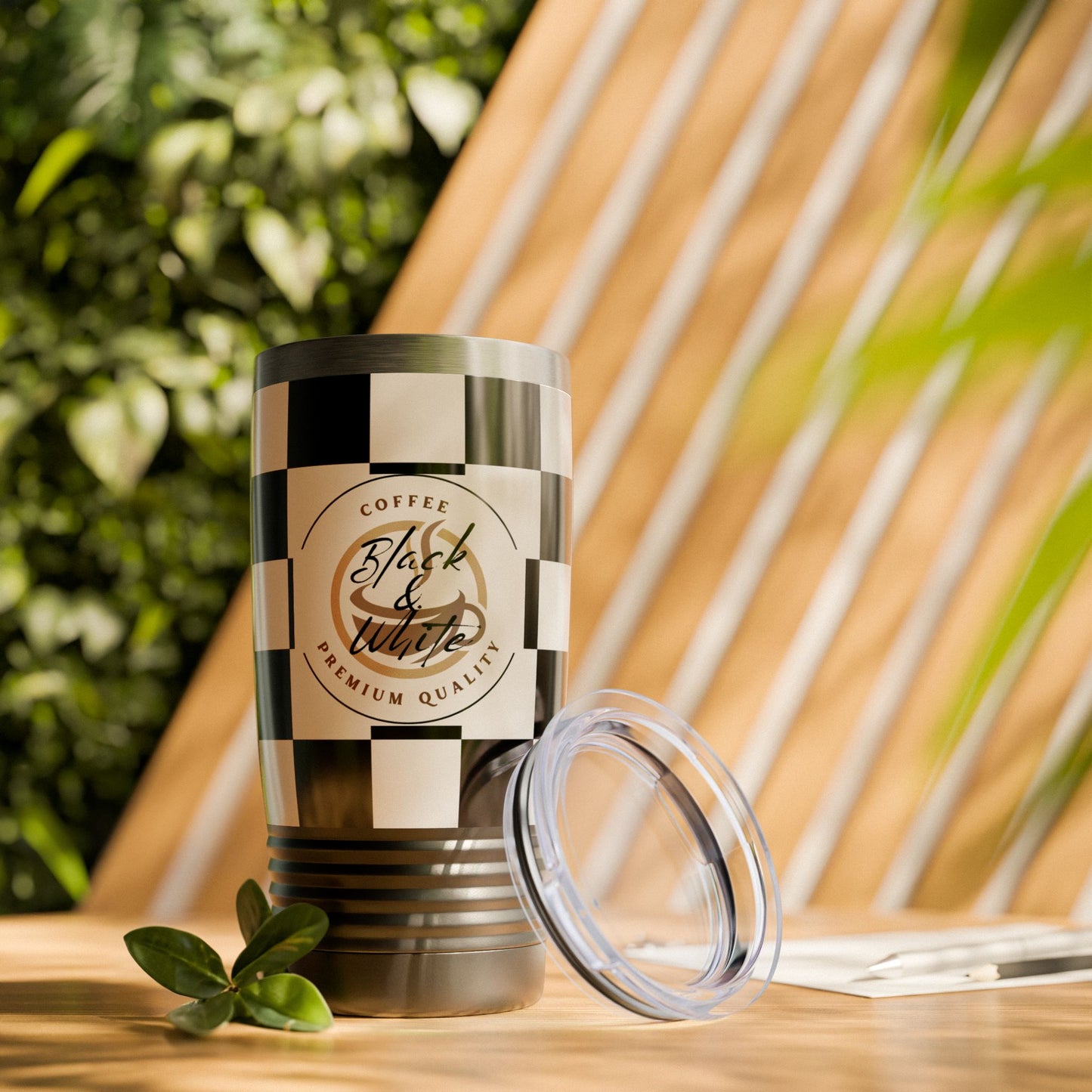 Chic Black & White Checker Print Tumbler 20oz travel mug with spill-resistant lid and ribbed grip on wooden table.