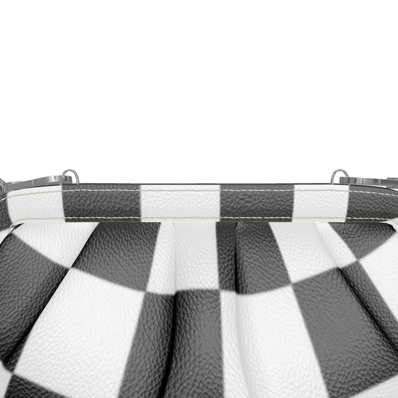 Close-up view of a pleated soft frame bag with a bold black and white checkerboard design.