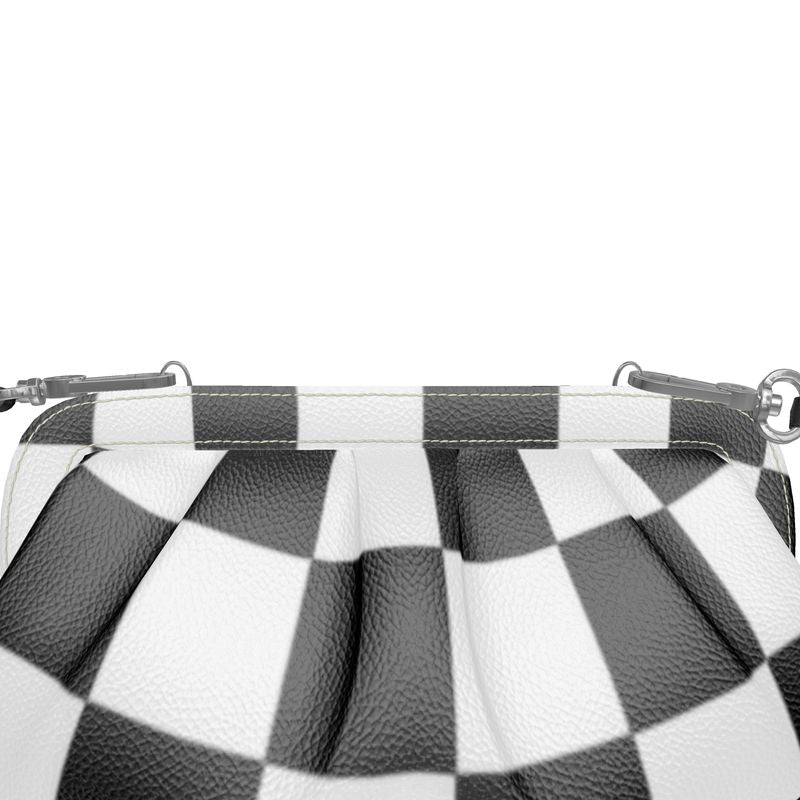 Close-up of a designer pleated soft frame bag featuring a black and white checkered pattern.