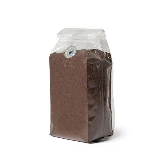 A sealed transparent bag of ground coffee.
